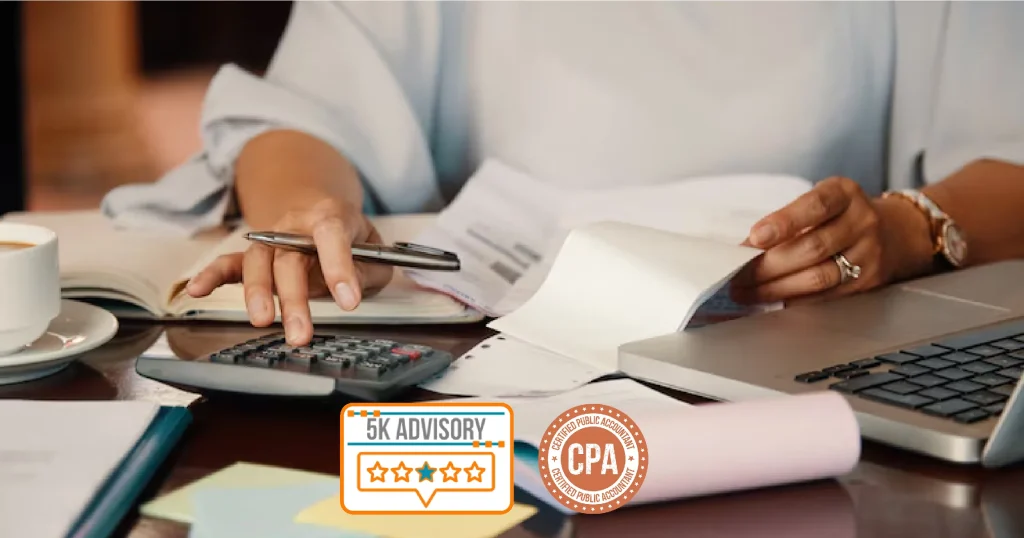 Certified public accountant calculating finances with laptop, calculator, and financial documents on desk – representing professional accounting services
